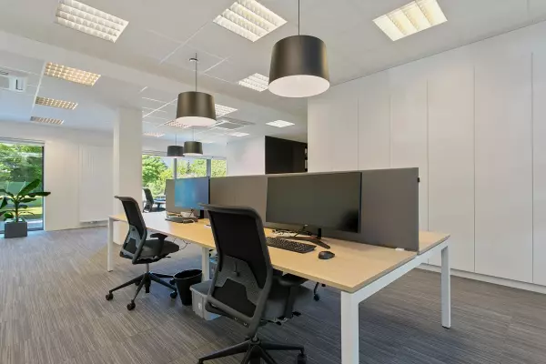 Desk with ergonomic office chairs and acoustic walls